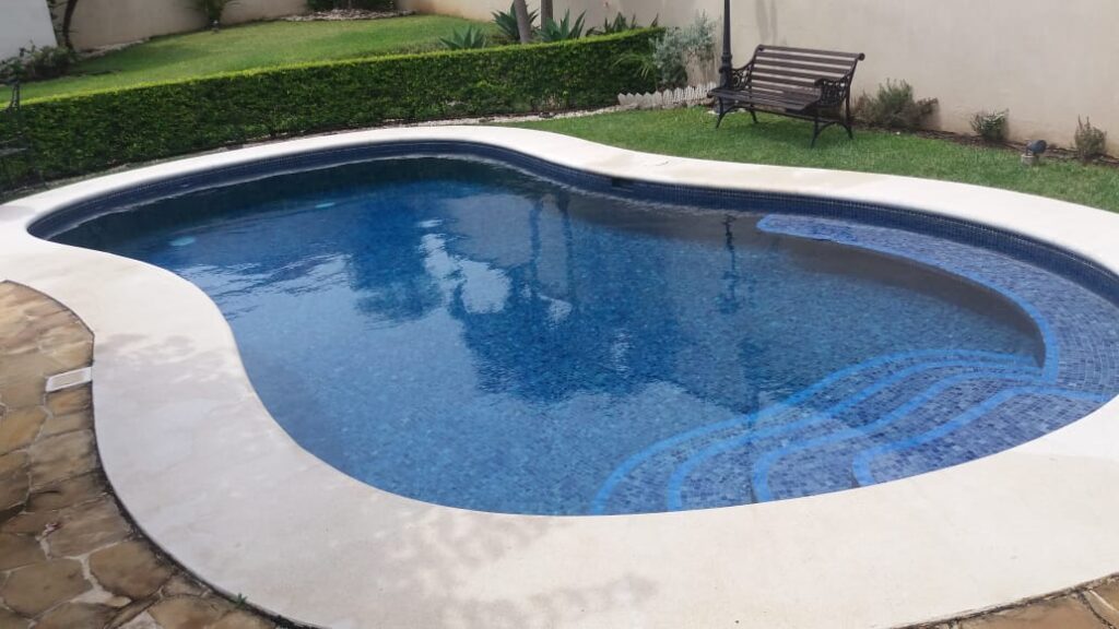kidney shaped pool construction, in santa ana