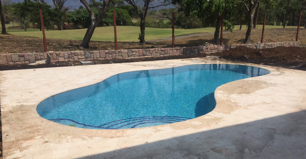 pool contractor built this blue tiled materpiece, around a golf course